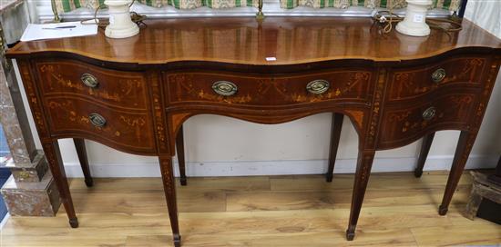 An Edwardian inlaid mahogany serpentine fronted sideboard, with brass railed back W.198cm
